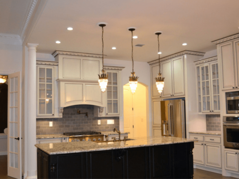 Galley kitchen detail with green lower cabinets and long counter
