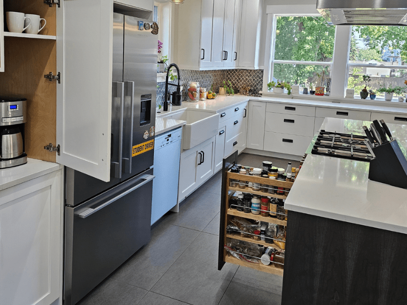 Kitchen with pull-out spice organizer and farmhouse sink