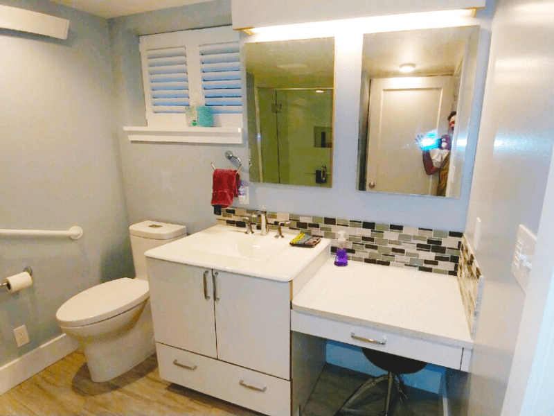 Accessible bathroom remodel with mosaic backsplash and grab bars