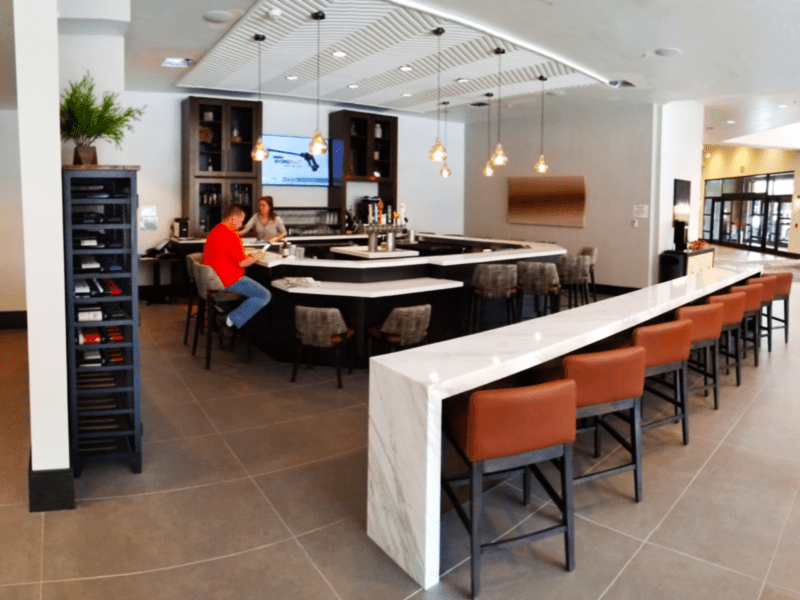 Commercial-grade bar with waterfall marble counter and leather seating